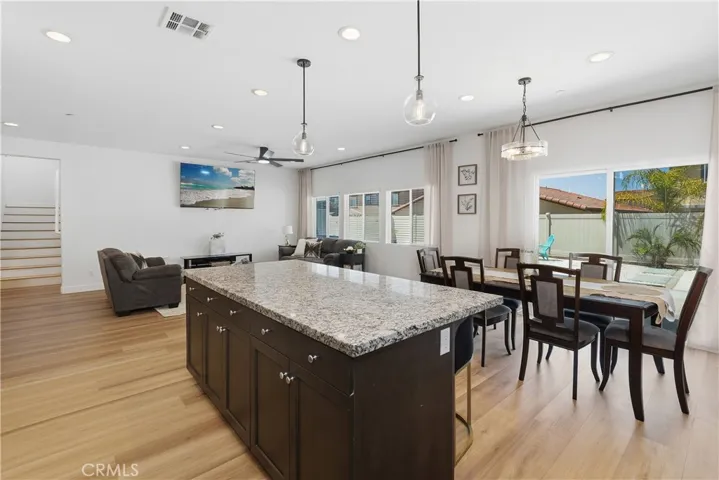 Gourmet kitchen with island seating opening to great room