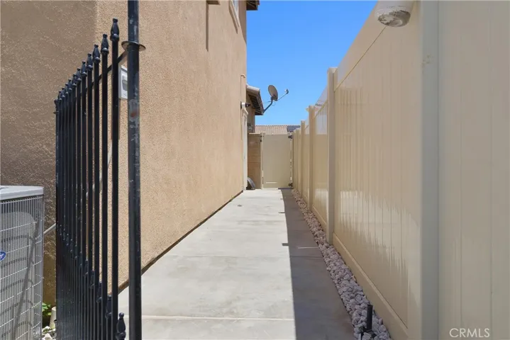 Side yard thoughtfully designed as a dedicated dog run—perfect for pets to play and roam