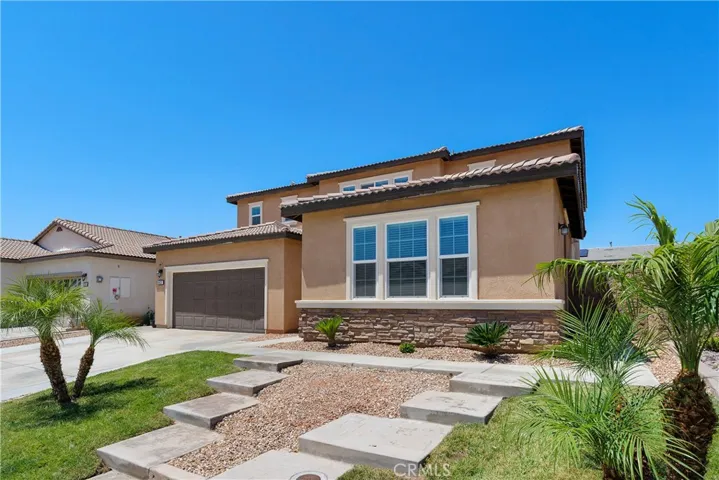 Front exterior features welcoming steps leading to two separate entrances—enhancing both curb appeal and functionality