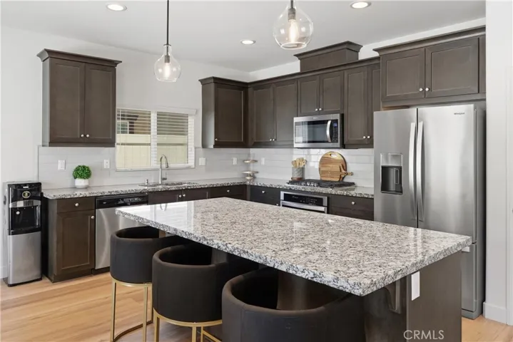 Open-concept gourmet kitchen with island bar seating