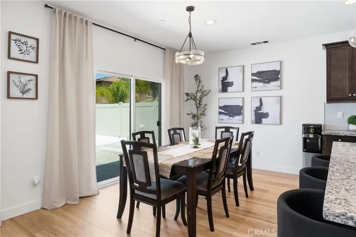 Dining room adjacent to the kitchen with a glass slider opening to the exterior for easy indoor-outdoor living