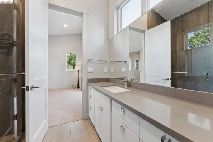 Modern vanity featuring an integrated sink, expansive countertop, and chrome hardware