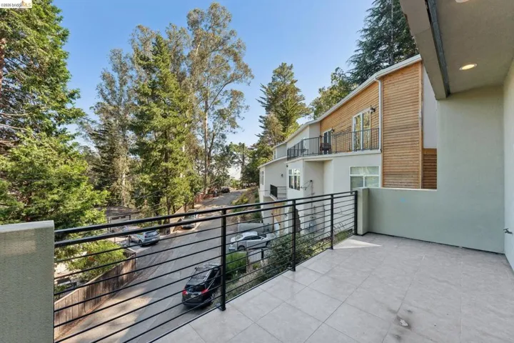 Exterior balcony featuring tile flooring and black metal railings