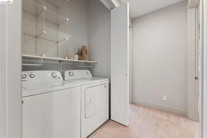 Dedicated laundry area featuring a white washing machine and dryer
