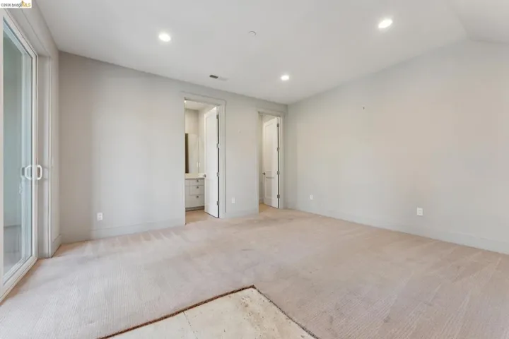 Spacious room with light-toned carpeting and neutral wall tones