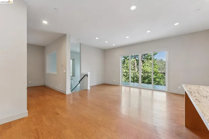 Open-concept living area featuring hardwood flooring and recessed lighting