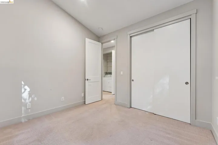 Wall-to-wall carpeting with light-toned walls and trim