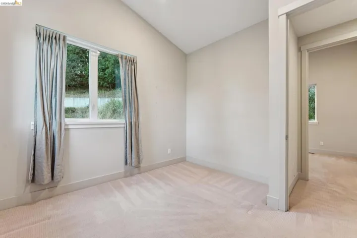 Room featuring neutral-toned carpeting and light gray walls