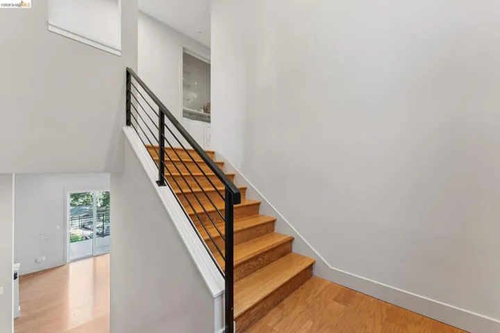 Hardwood staircase with contemporary black metal railings