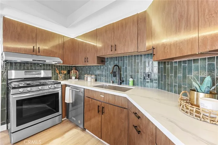 Quartz countertops and juniper polished porcelain backsplash tile.