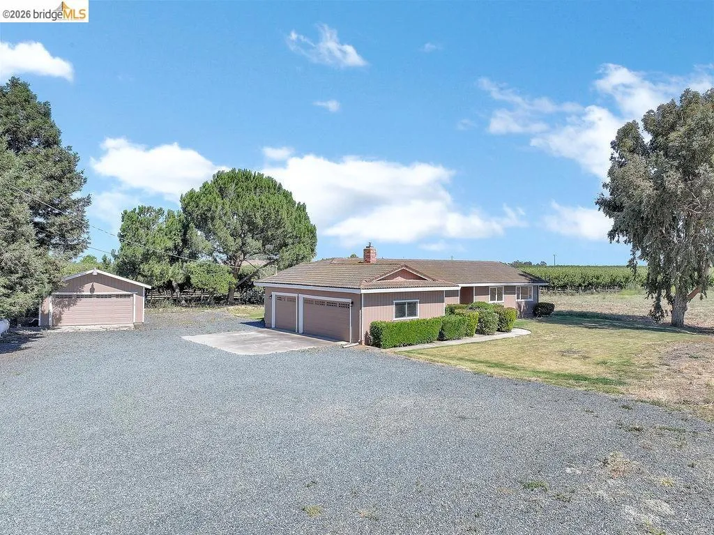 Ranch-style residence featuring a two-car attached garage with a separate detached single-car garage
