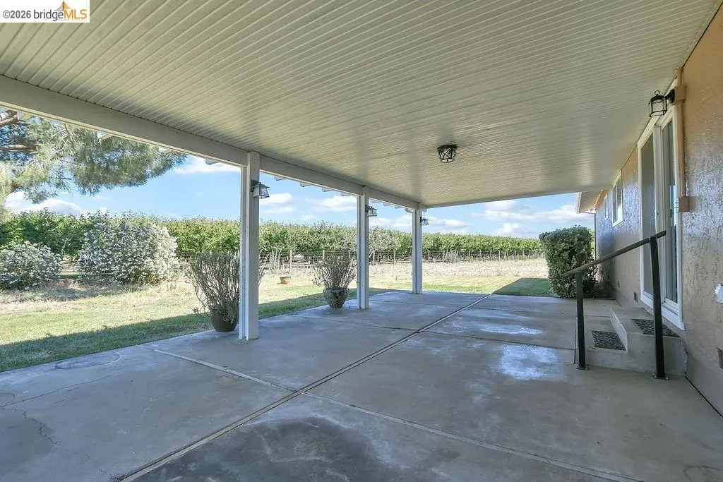 Expansive covered patio featuring a concrete surface and recessed lighting