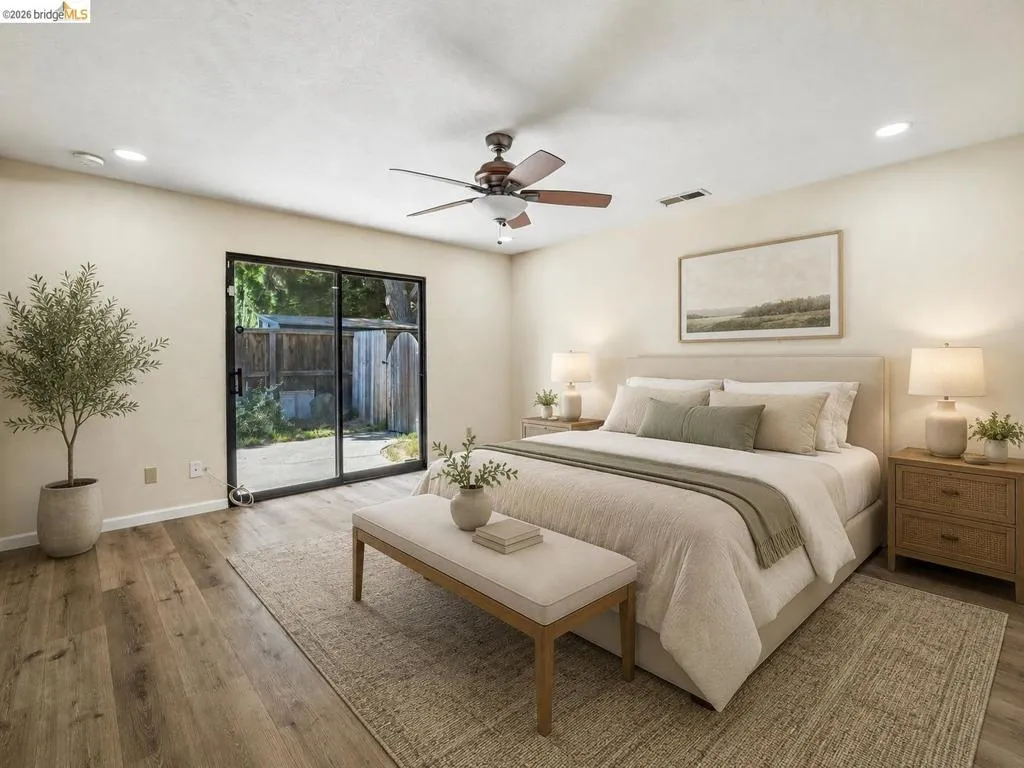 Wood-finish flooring with recessed lighting and a ceiling fan