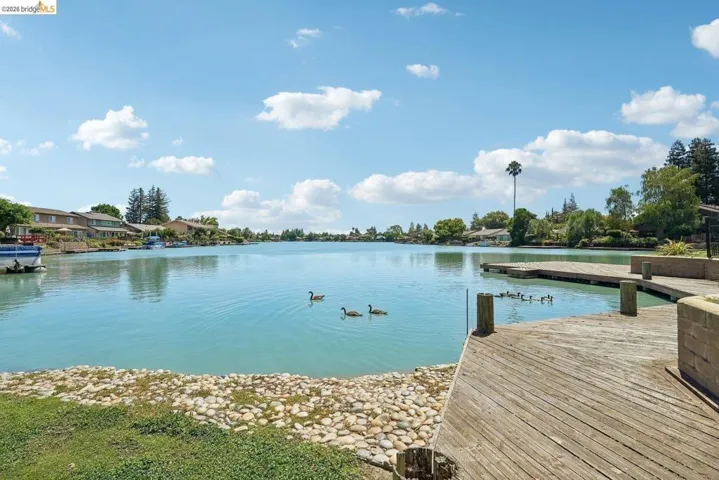 Expansive waterfront with private wooden decking and a rocky shoreline