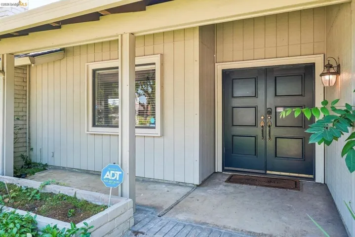 Double entry doors with paneled detailing and dark hardware