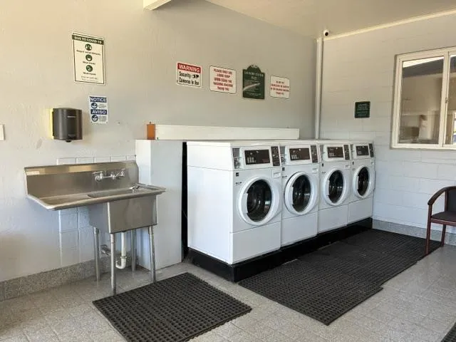 Laundry Room Features 4 Modern Washers plus Utility Sink.