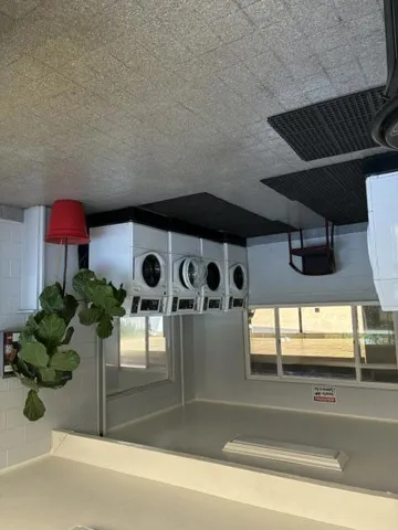 4 Modern Dryers in Laundry Room.