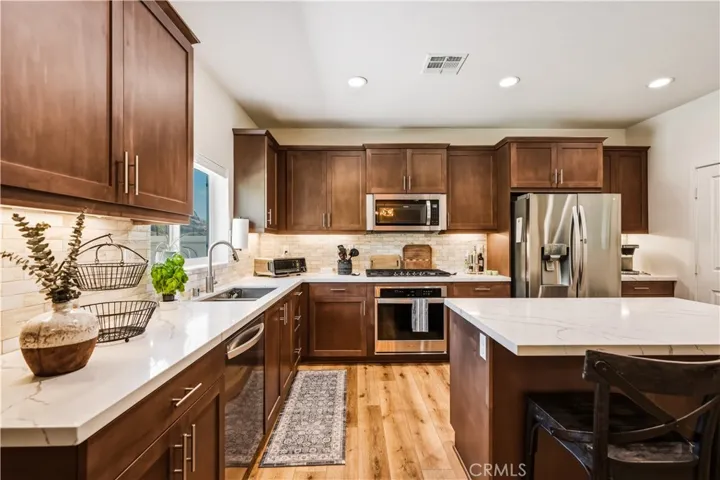 Island kitchen with custom back splash and walk in panty