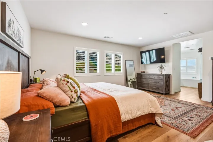 Primary Suite with vinyl plank floors and shutters