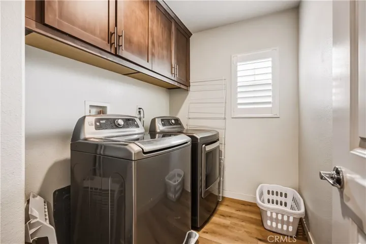 laundry room upstairs with cabinets