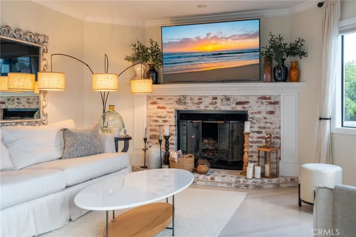 A natural brick finish on the fireplace enhances the comfort felt in the living room.