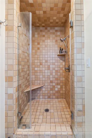 A comfortable shower with a bench to relax on