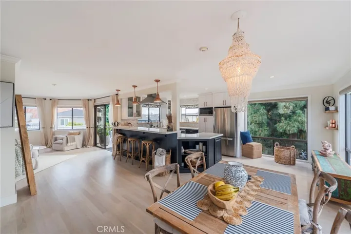 View from the stairs and dining area to the kitchen, living room and deck.