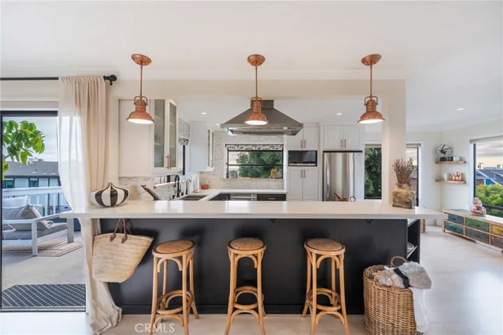The kitchen bar is an inviting place to relax and discuss the day