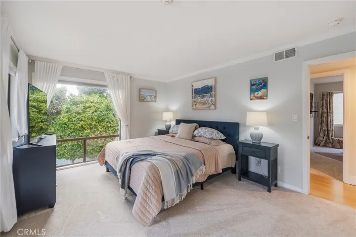 Main bedroom area with natural lighted windows and private deck