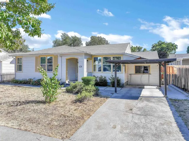 White exterior siding with yellow window trim and shutters