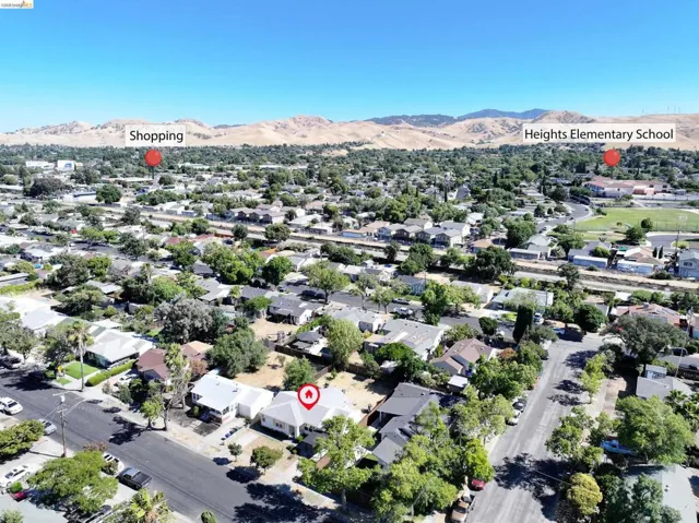 Aerial perspective showcasing a residential neighborhood with tree-lined streets