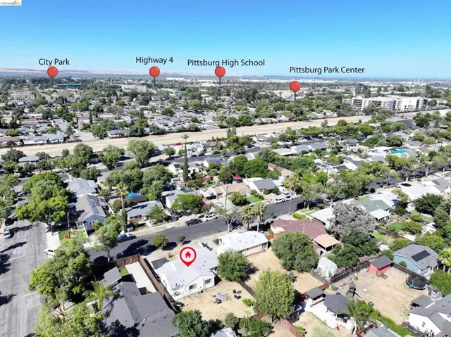 Aerial perspective showcasing a residential neighborhood with established trees and surrounding community amenities