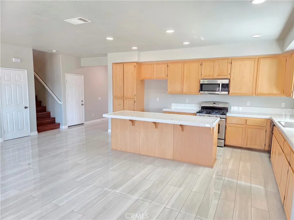 Kitchen opened to staircase and under staircase storage/coat closet
