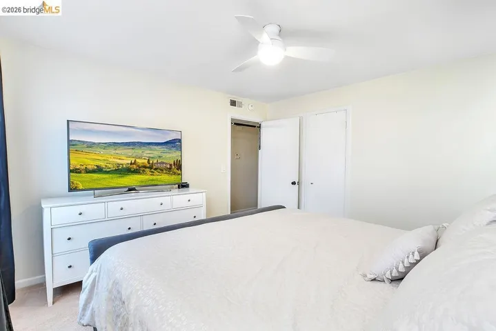 White walls and light-colored carpet provide a bright aesthetic