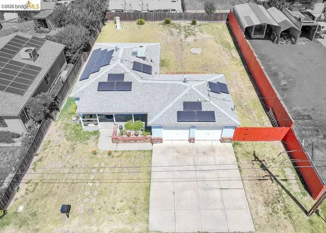 Gable roofline residence featuring solar panel installations, an attached two-car garage, and a concrete driveway