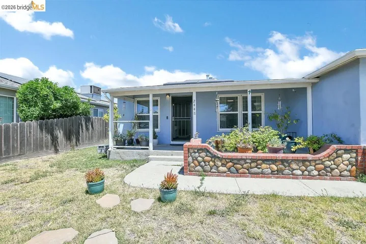 Front exterior featuring a covered porch, light blue exterior, and white trim.