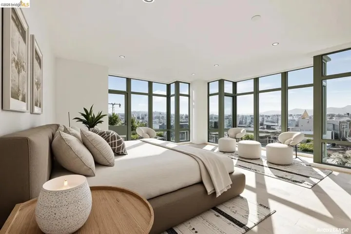 Floor-to-ceiling windows with green frames, recessed lighting, light wood-finish flooring, white walls, and a private balcony