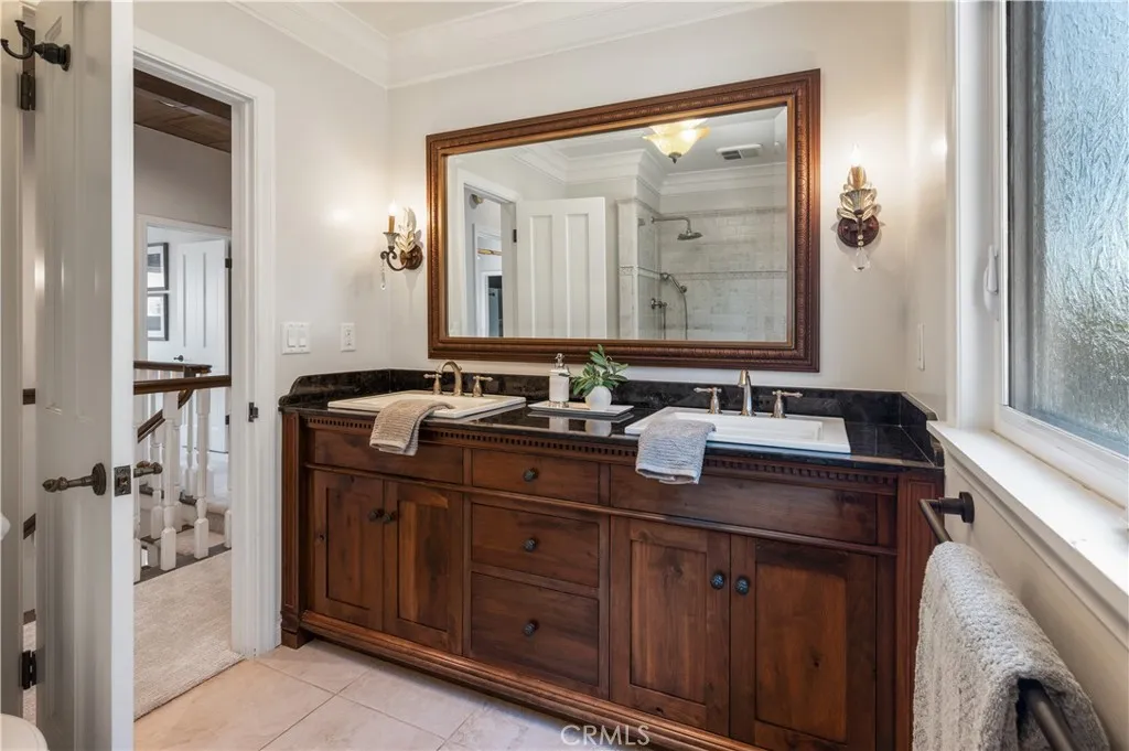 guest bathroom with dual sinks.
