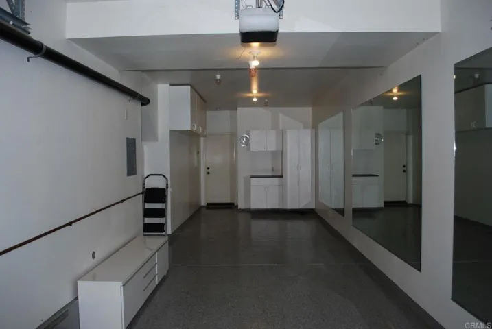 2 car tandem garage with epoxy floors and storage cabinets