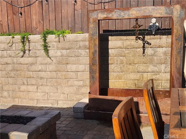 Fountain against back wall of back yard.