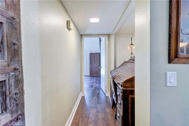 Hallway to Primary bedroom which is on the opposite side of the house from the other two bedrooms