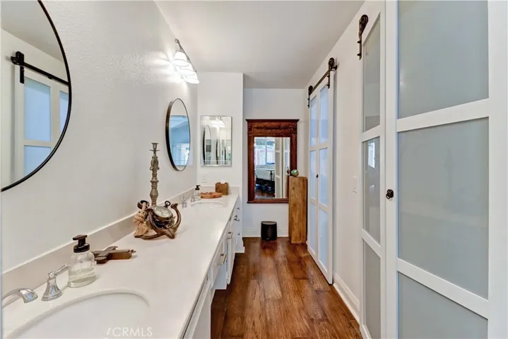 Primary Bathroom with upgraded frosted glass doors to toilet/shower area and huge closet