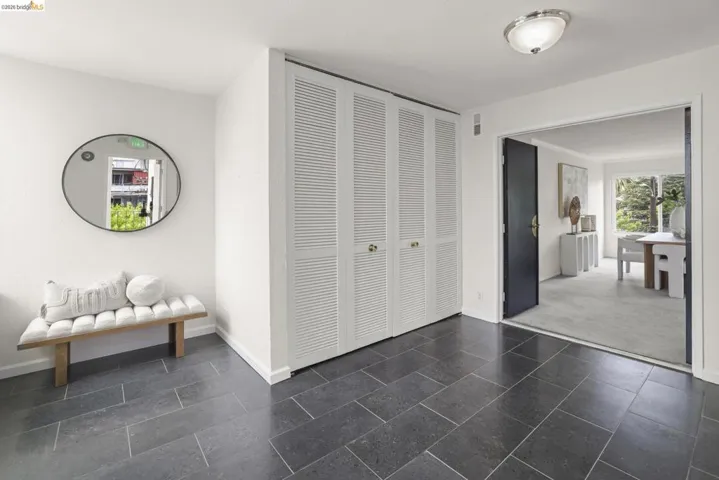 Entryway featuring dark gray rectangular floor tiles and white walls