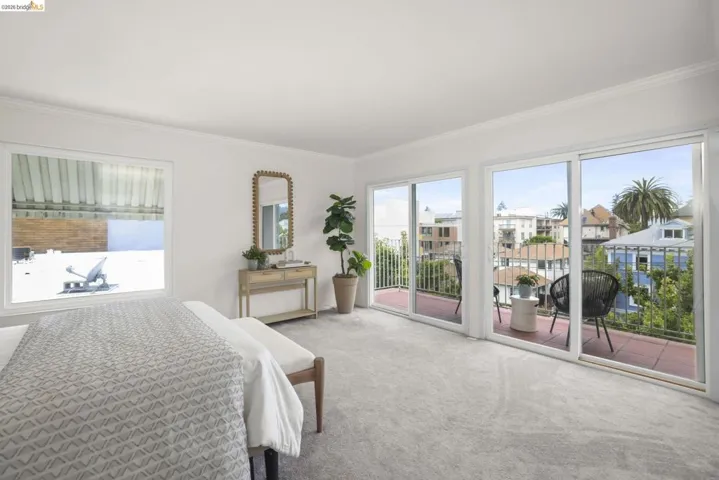 Bright room featuring light gray carpeting and white walls