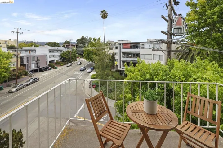 Exterior balcony with a concrete surface and a white metal railing
