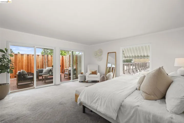 Bright room with gray carpet flooring and white crown molding