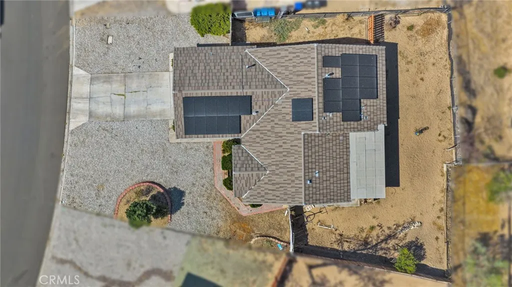 True birds-eye vertical aerial view serves as a visual plot map, cleanly outlining the entire lot boundary lines, back roofline solar layout, and yard perimeter.