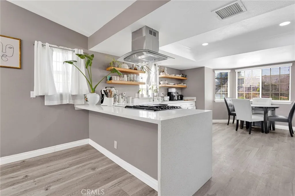Alternate kitchen perspective showcasing the extensive counter workspace, open layout flow, and clean, high-end design elements.