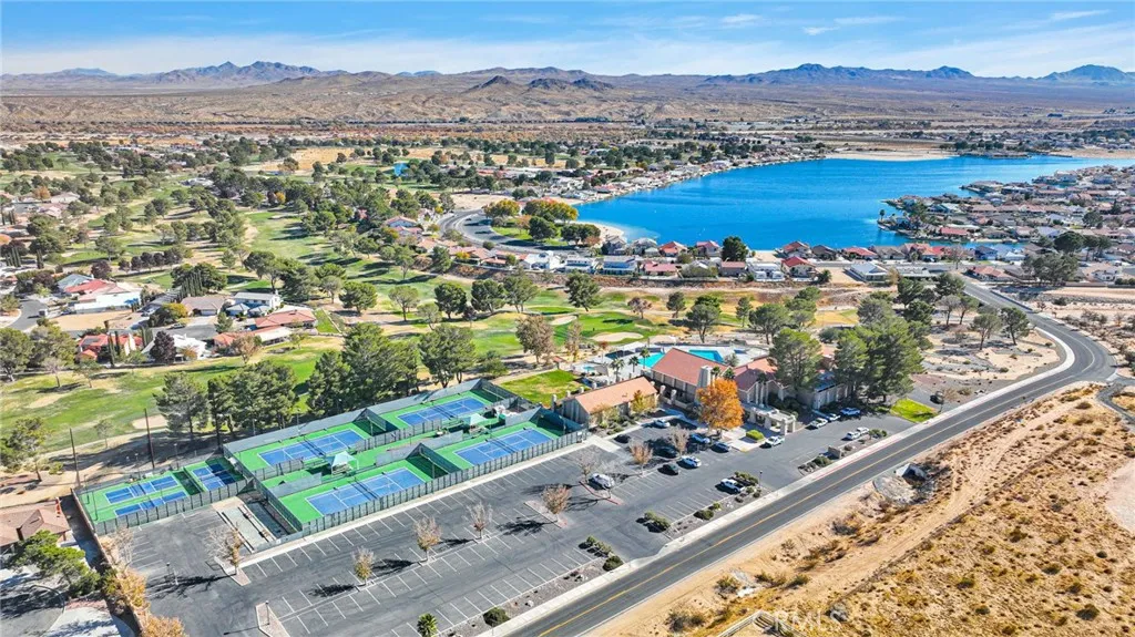 Sweeping community view highlighting local amenities including a 27-hole championship golf course, sandy beaches, boating, and fishing docks.