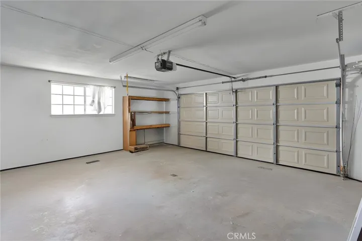 Oversized 2-car garage features a spacious layout, excellent overhead lighting, and ample room for vehicles, storage, or a dedicated workspace.